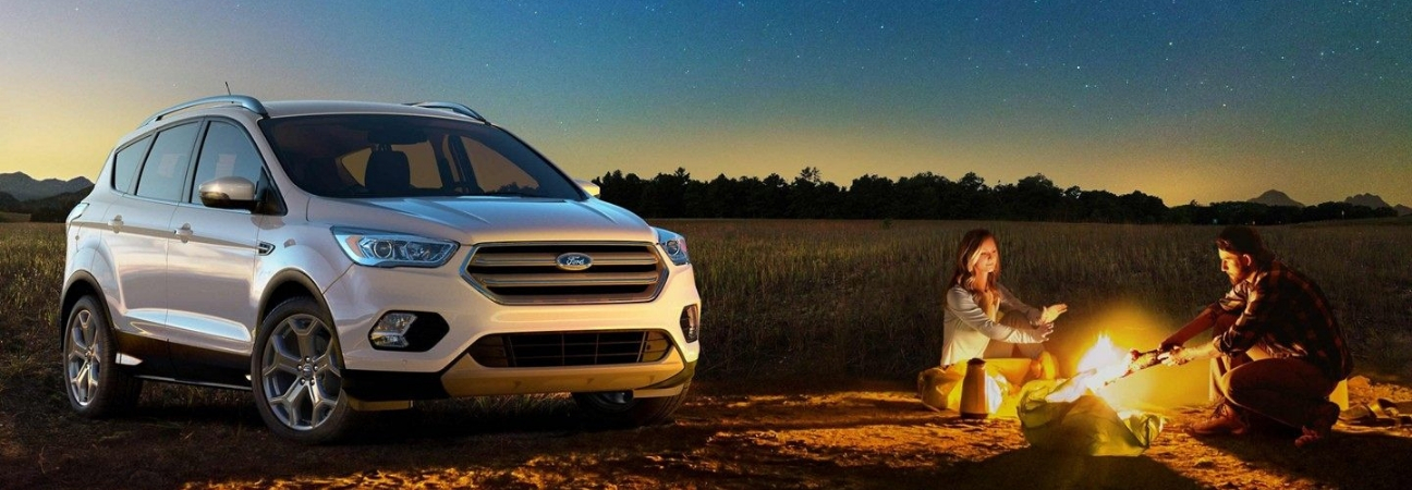 Couple camping around a 2019 Ford Escape
