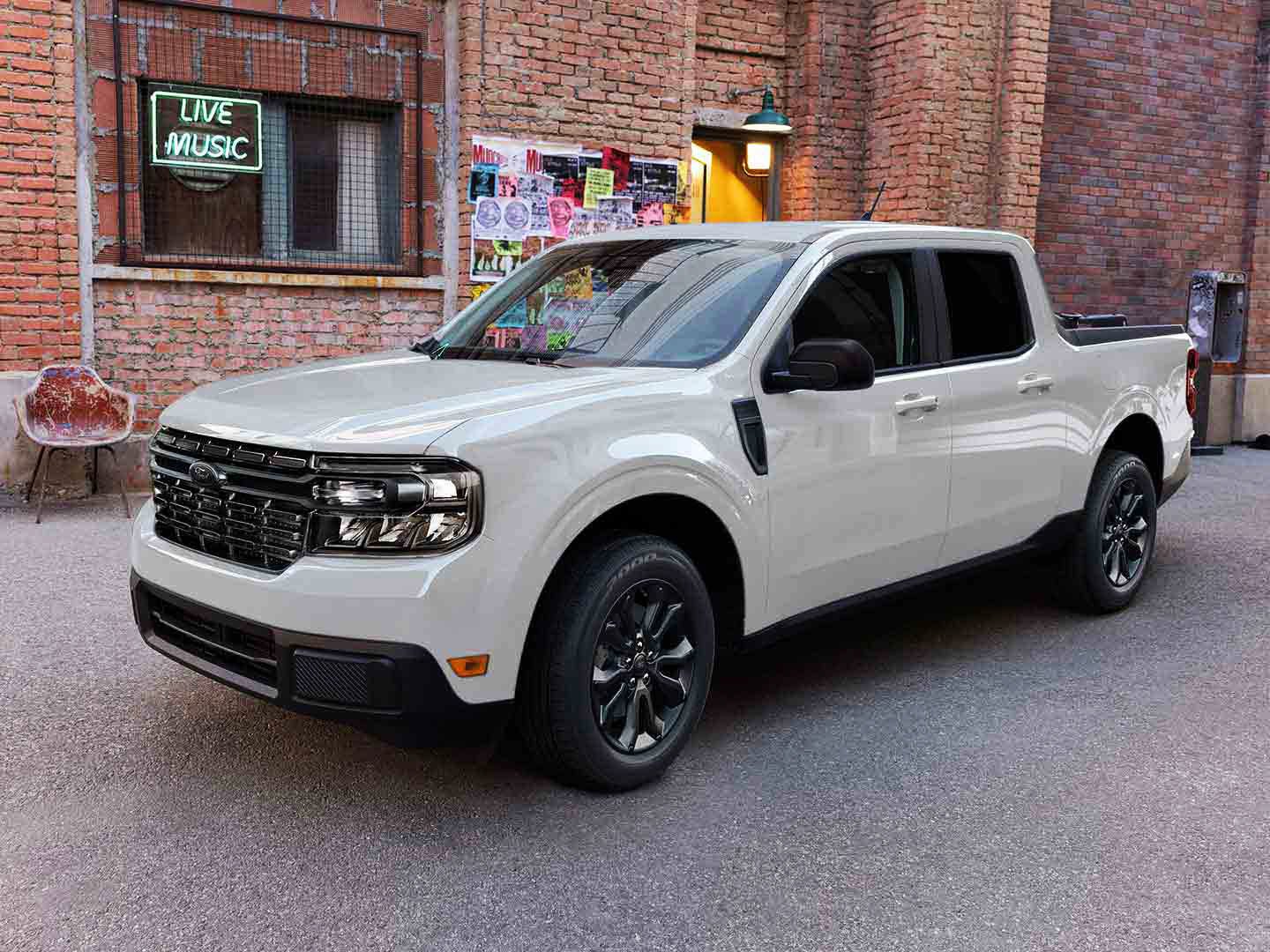 A white ford truck parked front of building